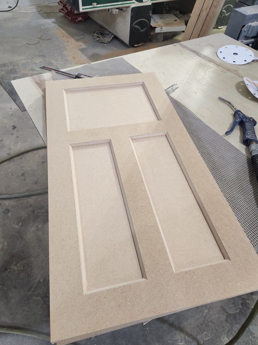 One-piece MDF craftsman cabinet door with one wide top panel and two tall lower panels