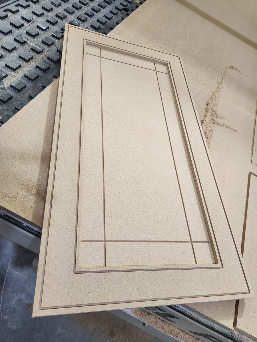 One-piece MDF cabinet door with a recessed panel and crossing mission-style grooves at the corners